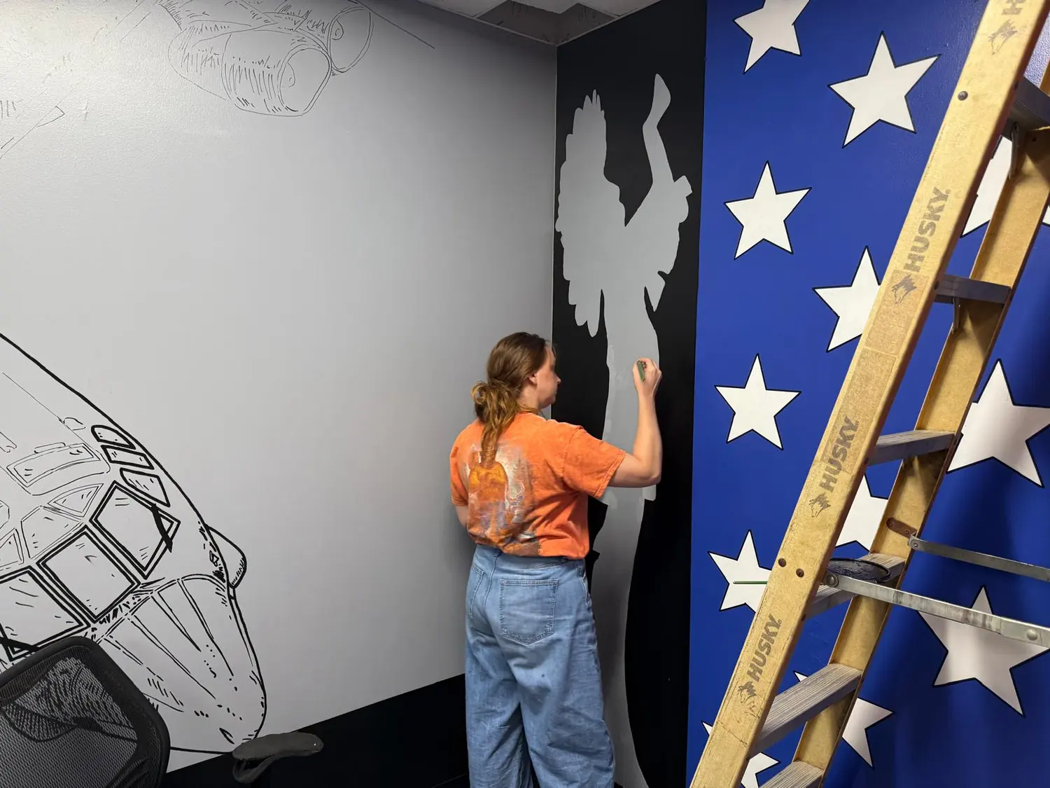 Michelle Evalle creating an Air Force mural